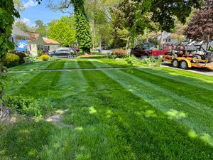 Our Mowing service offers precise, reliable lawn care for a pristine yard. Our experienced team ensures even cuts and neat edges to enhance your home's curb appeal and promote healthy grass growth. for Adams Landscaping in Springfield, MA