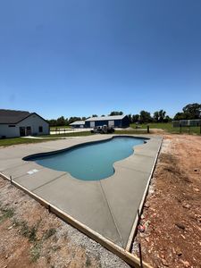 Transform your outdoor space with our durable and stylish pool decks. Our expert team designs and installs high-quality concrete surfaces providing safety, beauty, and longevity for a perfect backyard oasis. for Modern Concrete LLC in Lowell, AR