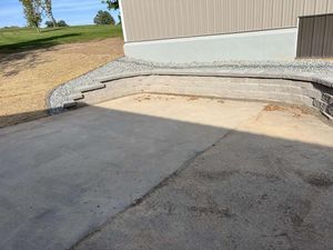 Our Retaining Wall Installation service enhances landscape stability and aesthetics. Pair with our affordable artificial turf installation cost options for a low-maintenance, visually appealing backyard transformation that maximizes your outdoor space's potential. for Davis Landscaping in Wilson, WI