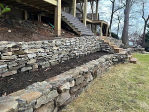 Our retaining wall construction service offers durable, aesthetically pleasing solutions to manage soil erosion and enhance your landscape's functionality and beauty, increasing safety while complementing your home’s outdoor design. for Mountain View Lawn Care and Detail in Seneca, SC