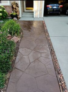 Our Stamped Concrete Installation service offers a variety of customizable designs and colors, providing a durable and low-maintenance solution that adds appeal and value to your home's outdoor space. for Co Custom Concrete and Overlays in Colorado Springs, CO