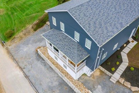 High aerial view of the finished blue-gray house