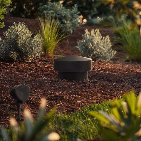 Outdoor landscape speaker set in a garden bed