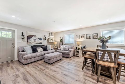 Open living and dining room with a gray plank floor in a finished home