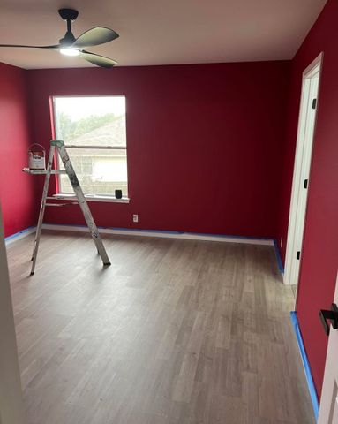Room repainted in a deep red with white trim