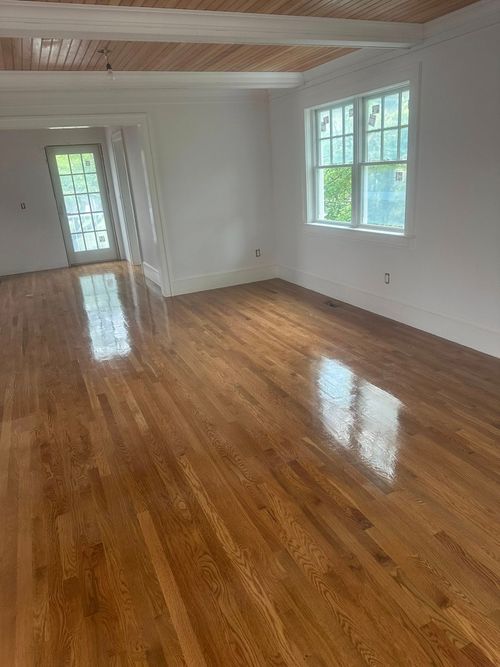 Glossy hardwood floor in a room with a wood ceiling