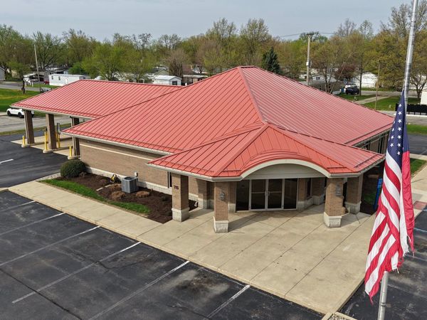 Red metal roof with a shingle profile on a commercial building