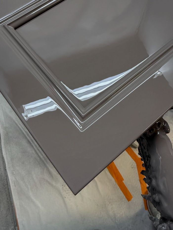 Cabinet door with a mirror-smooth brushed gloss finish