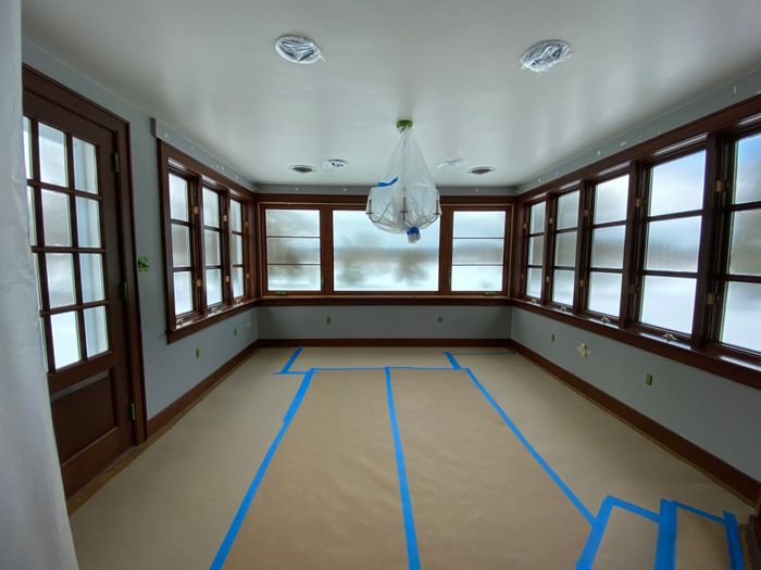 Sunroom floor papered and taped before painting