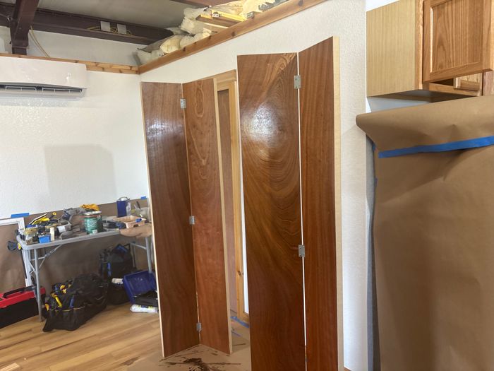Room mid-renovation with new sheetrock and doors staged
