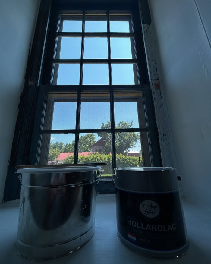 Paint cans staged at a farmhouse window