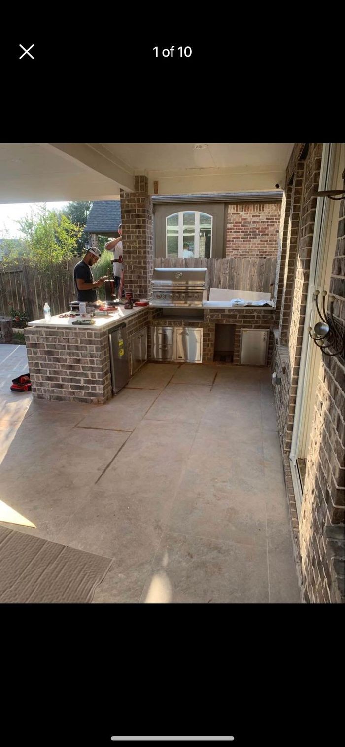 Outdoor Kitchen Construction by BJR Construction in Fulshear and Katy, TX: brick outdoor kitchen under a covered patio
