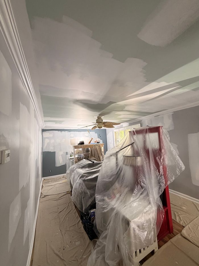 Room with furniture wrapped in plastic