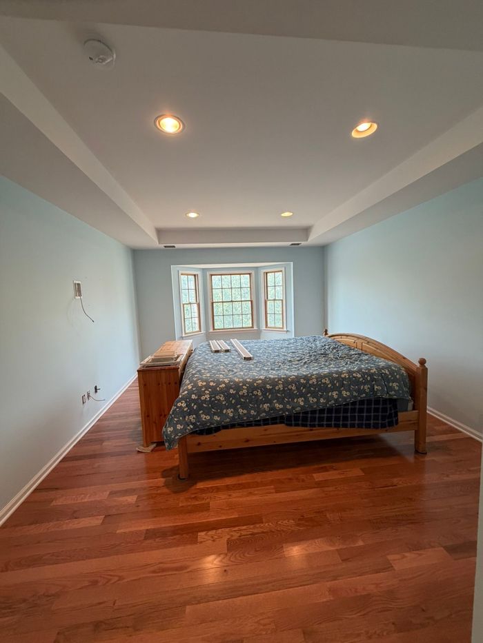 Bedroom with finished hardwood floors