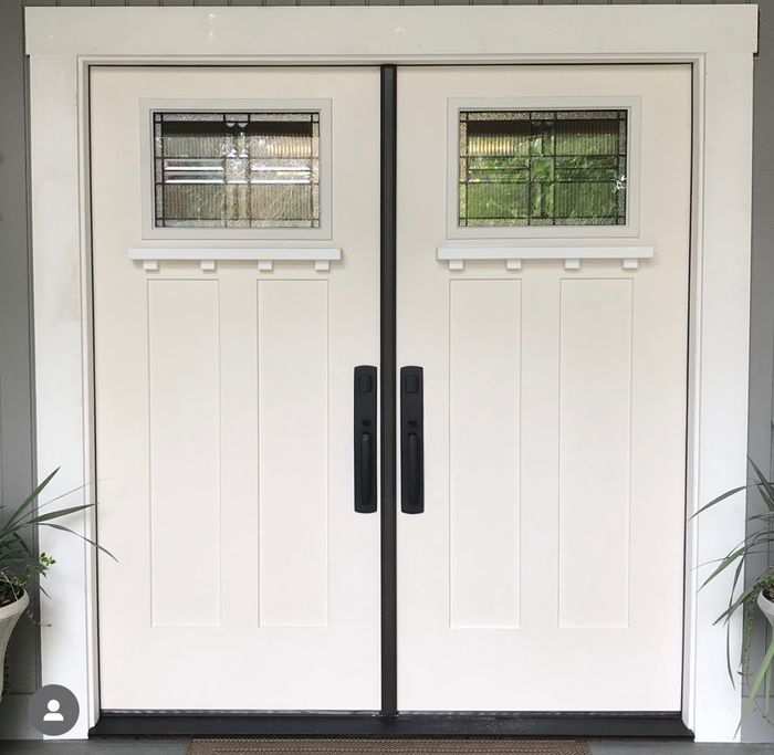 White double entry doors with leaded glass inserts after installation