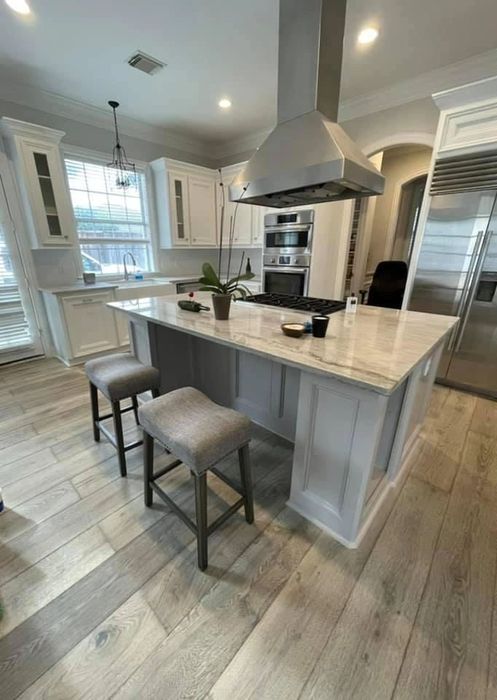 Finished kitchen with waterfall island and bar seating