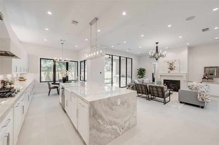 Remodeled open-plan kitchen and living area with a quartz island