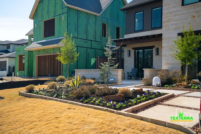Modern townhomes with new beds, rock and young trees