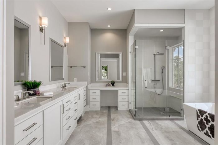 Master bathroom with tiled walk-in shower and long vanity