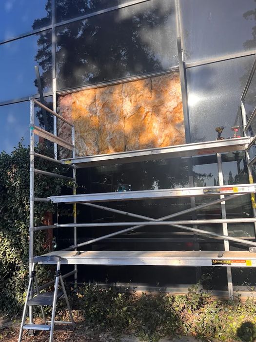Large glass panel being replaced on a building with scaffolding