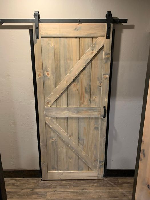 Rustic barn door on black sliding hardware