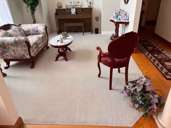 Formal living room with a clean rug and wood floor