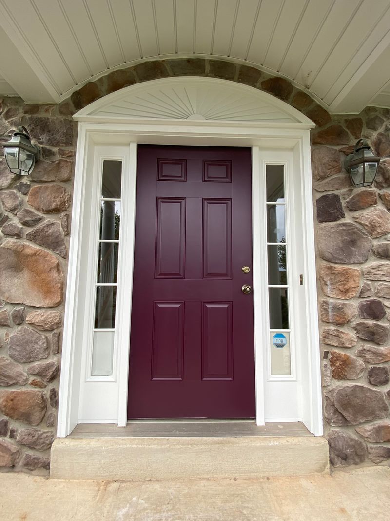 Plum front door in stone