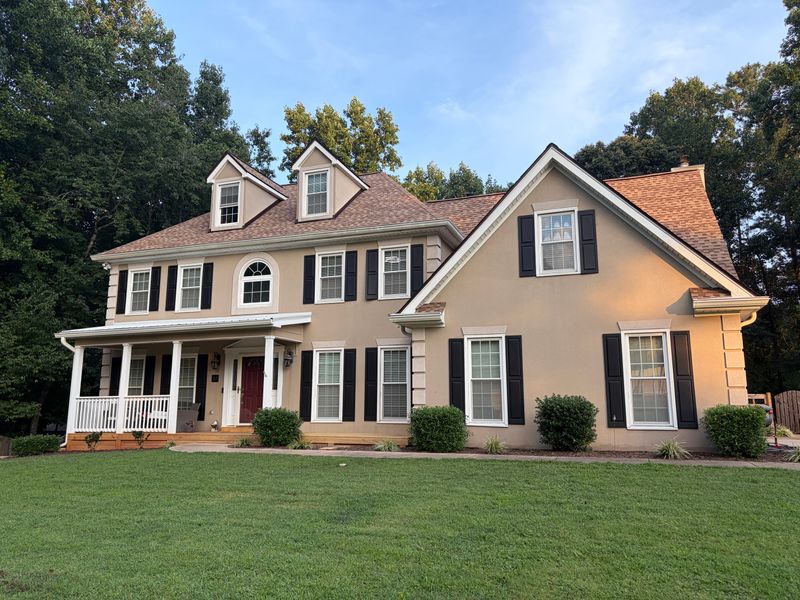 Two-story home with three dormers and a new roof