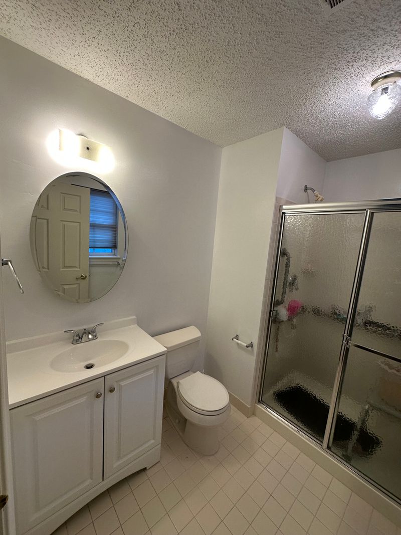 Bathroom with a tile floor and glass shower