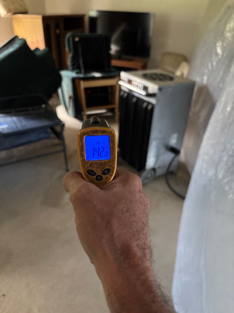 Infrared thermometer reading 142 degrees inside a treated home