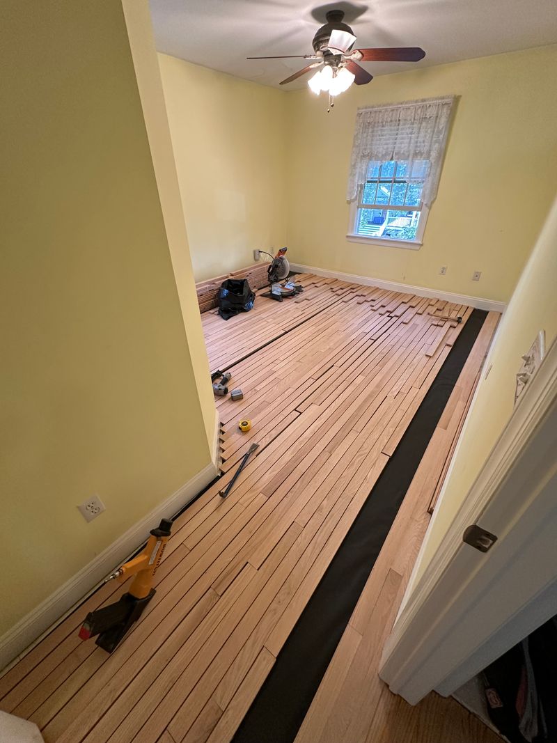 Hardwood boards going down during an install