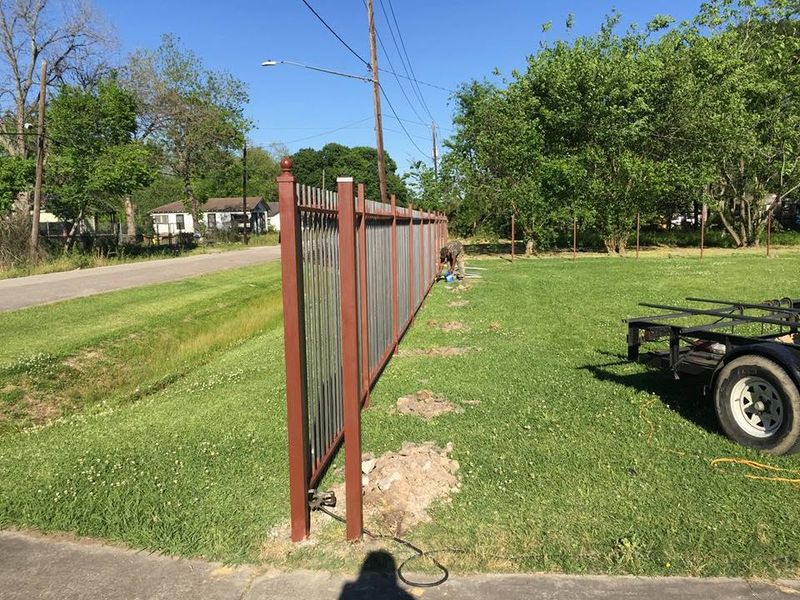 Rail fence being installed along a road