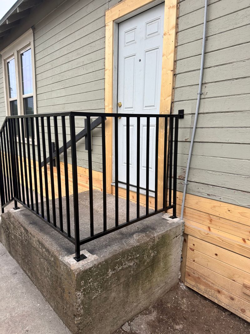 Iron rail on a concrete stoop