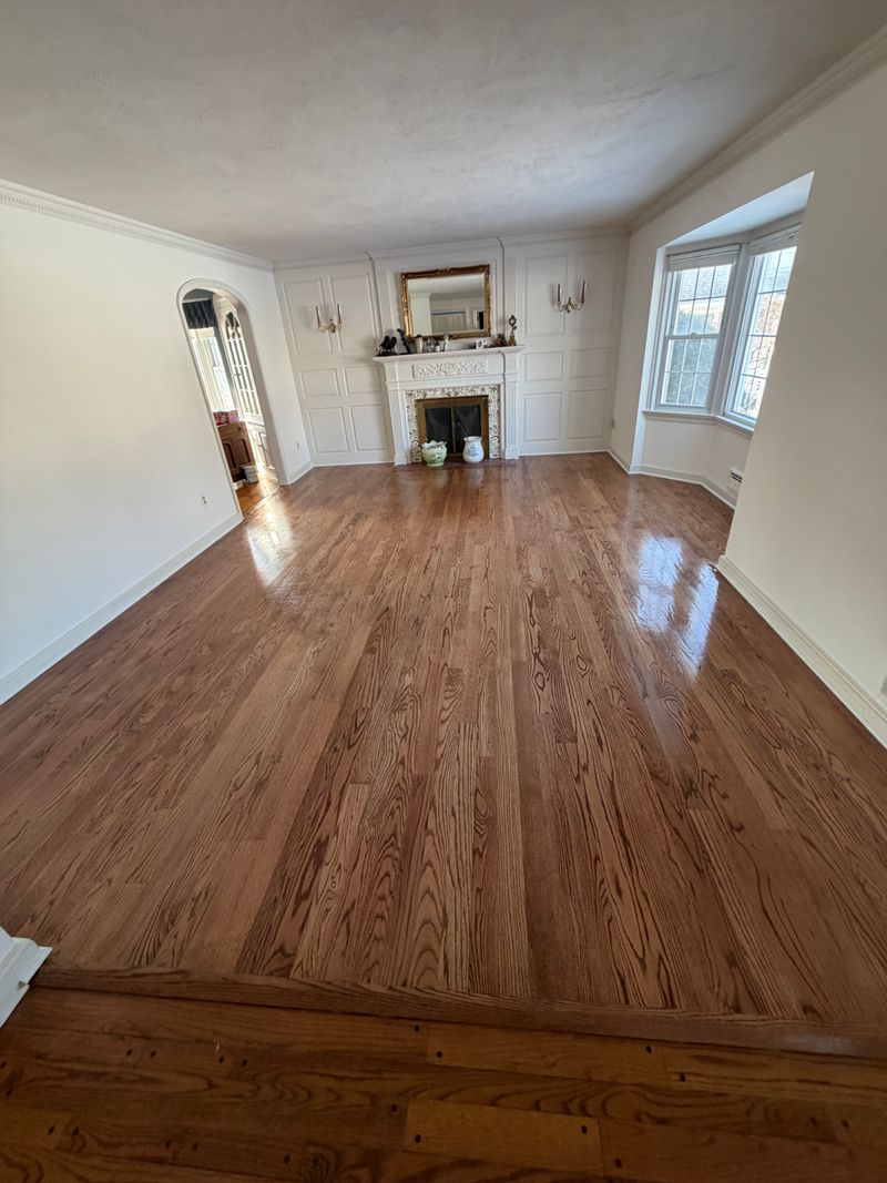 Refinished hardwood floor in a room with a fireplace