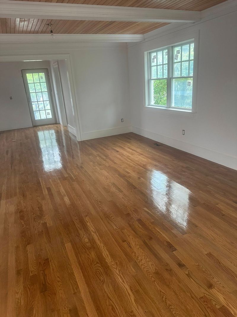 Glossy hardwood floor in a room with a wood ceiling