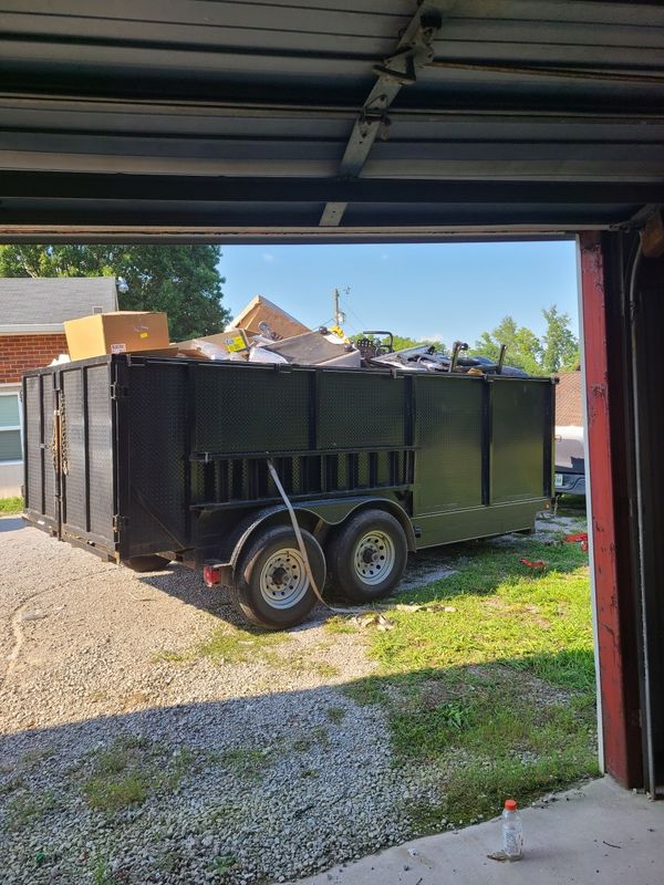 View from a garage out to a dump trailer in the driveway