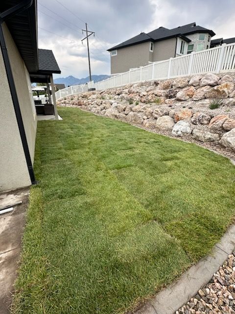 Backyard Transformation with Fresh Sod and Retaining Walls