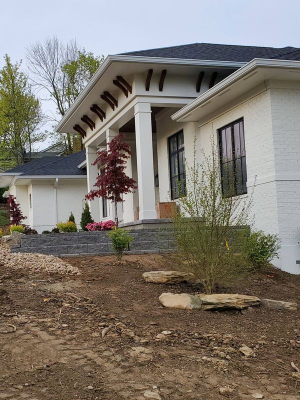White brick front entry with tall columns and black windows