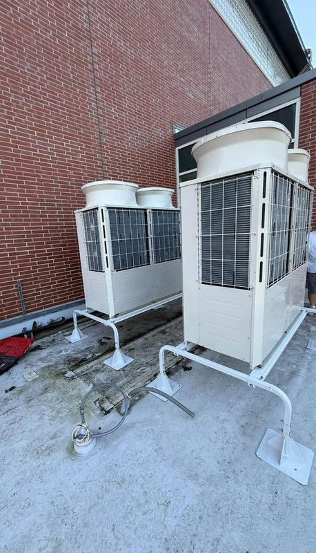 Outdoor HVAC equipment beside a brick building