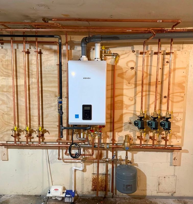 Tankless water heater and copper piping in a utility room
