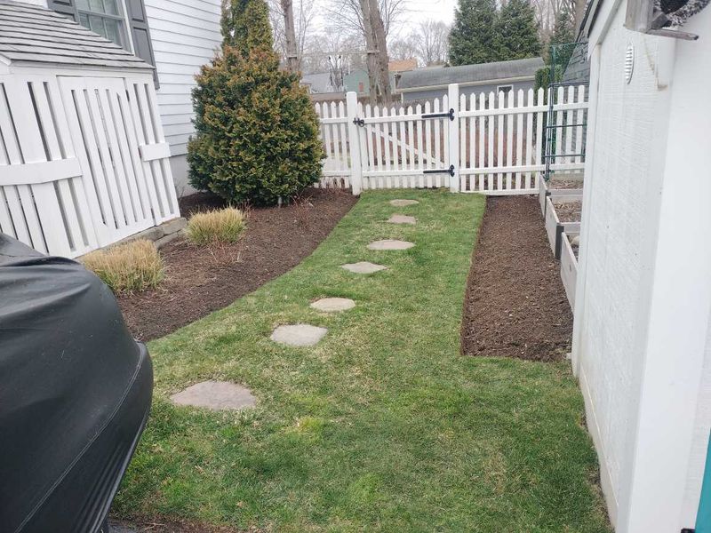 "Transforming East Greenwich: Elevating Outdoor Spaces with Expert Mowing and Mulch Installation by CHACH Landscaping & Construction"