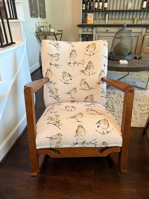 Wooden armchair upholstered in a bird-print fabric