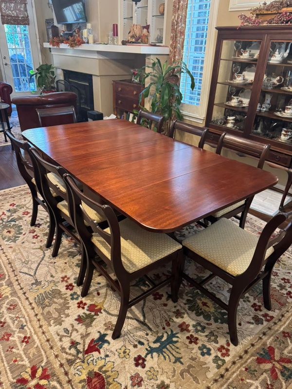 Mahogany dining table with matching chairs in a dining room