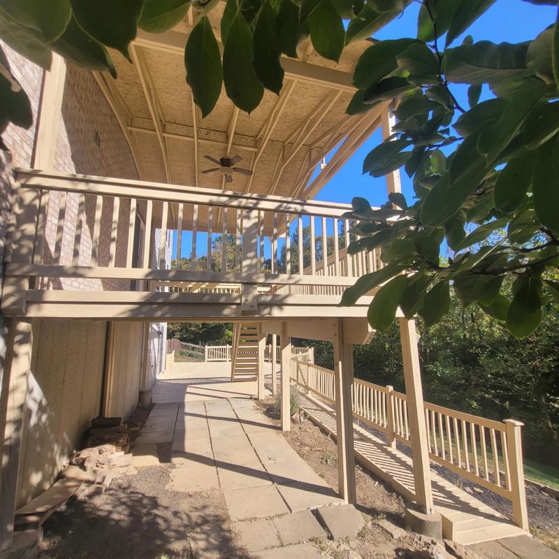 Two-level deck and stairs with a fresh finish behind a Cincinnati-area home