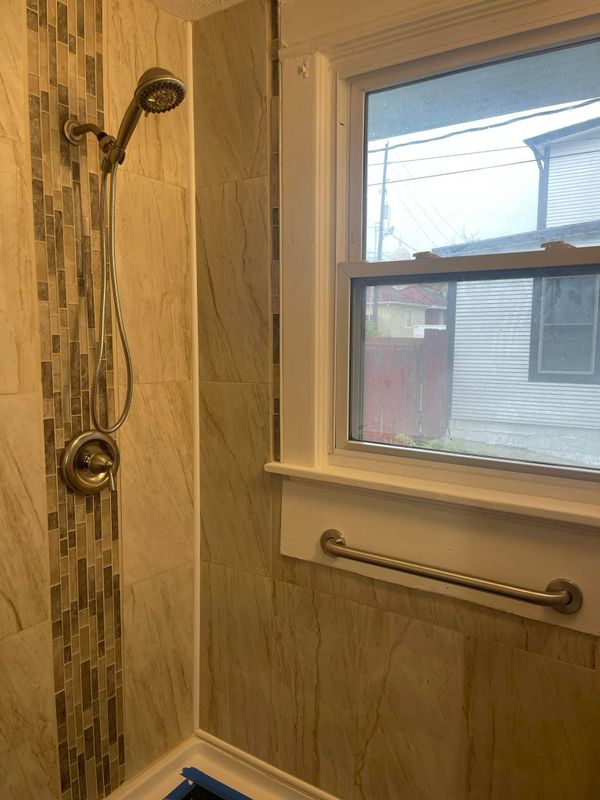 Finished shower with a window and grab bar