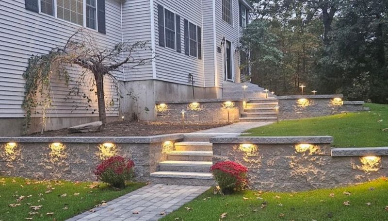 Transforming North Andover: Elegant Retaining Walls, Granite Steps, Paver Walkway, and Ambient Lighting by Brouder & Sons