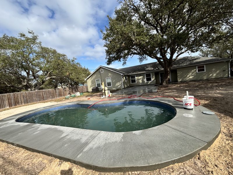 Transforming Outdoor Spaces: Custom Pool Installation with Elegant Concrete Decking by Kinetic Pools