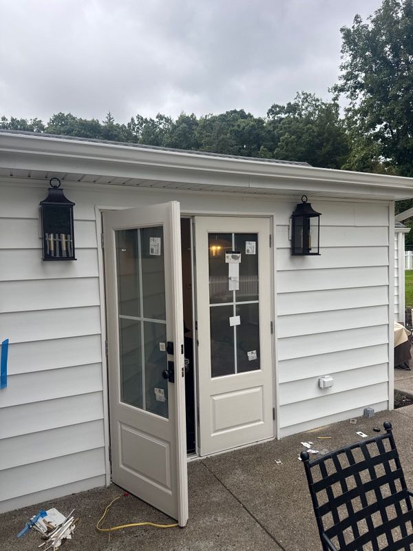French doors with lantern lights at the entry of the new addition