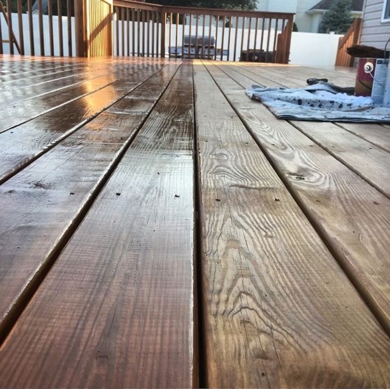 Close-up of freshly stained deck boards showing the wood grain after a coat of stain