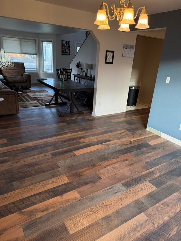 Finished dark wood-look plank flooring in a dining and living area